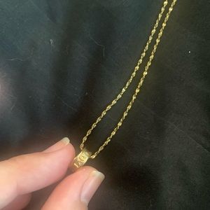 10k gold necklace with charm that says I love you